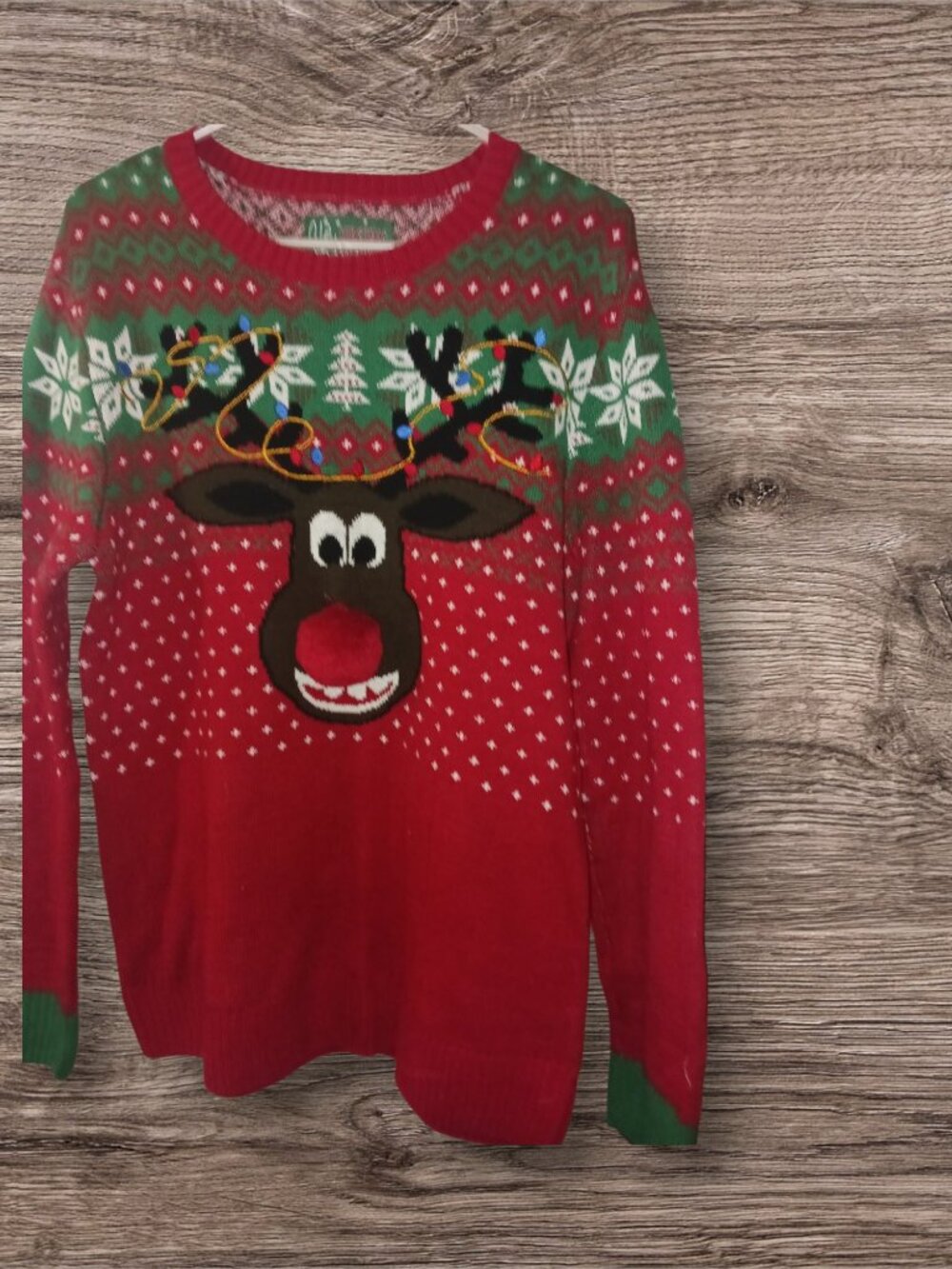 Fun ugly Christmas sweater featuring a reindeer wearing sunglasses and a festive